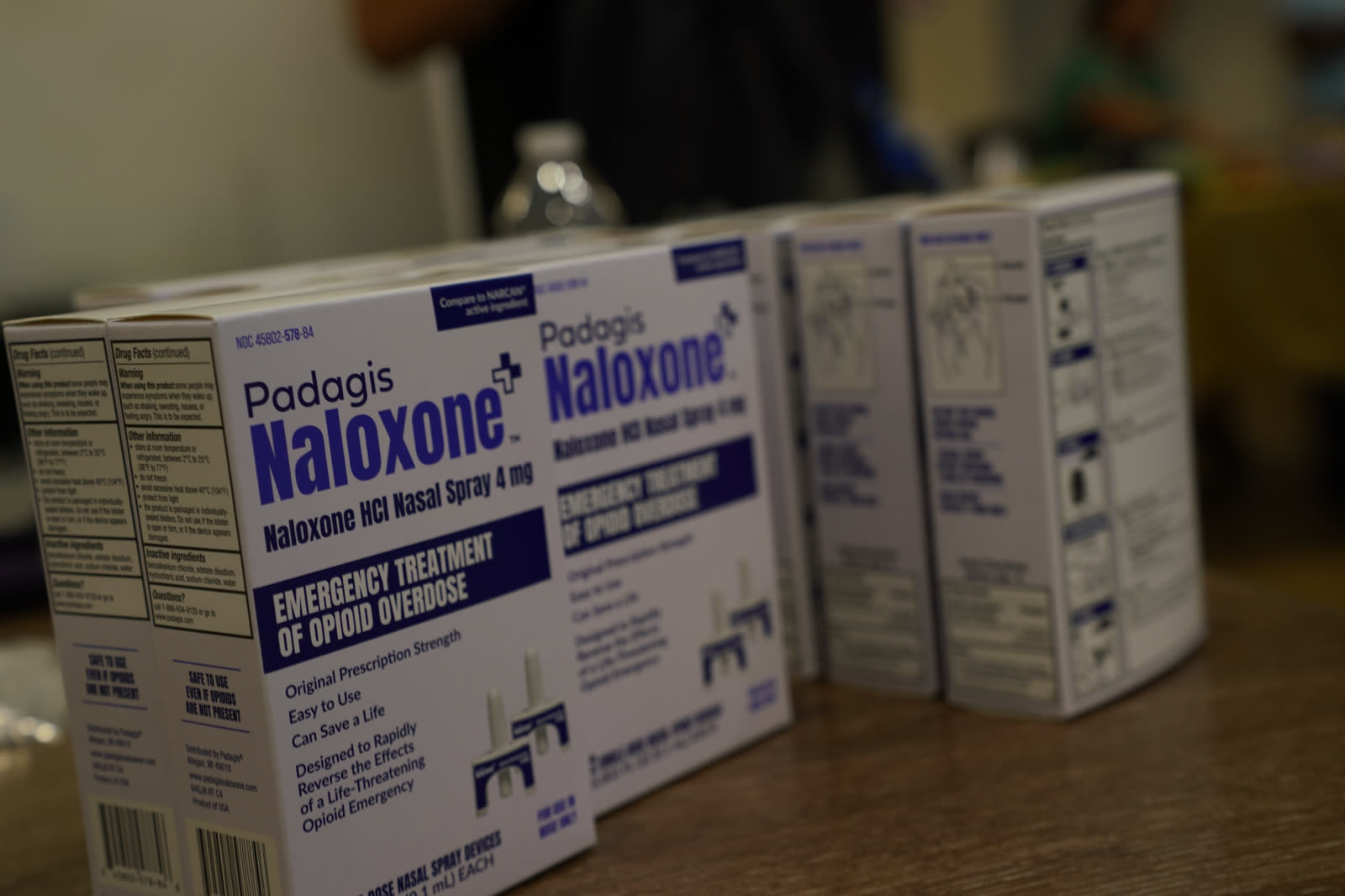 Boxes of Narcan nasal spray lined up on a table for free distribution