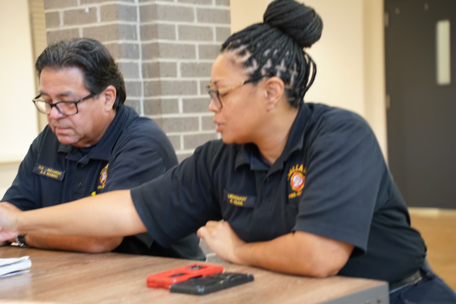 Community and emergency response representatives seated at a resource table